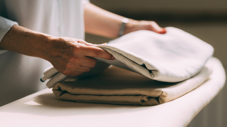 Someone folding linens