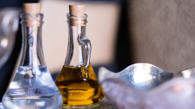 Olive oil and vinegar in two glass bottles
