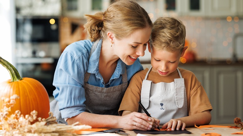 mom helps child with crafting
