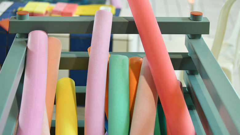 Container of multi-colored pool noodles