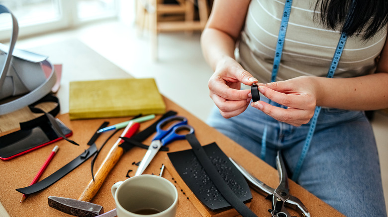 Person working on craft at table