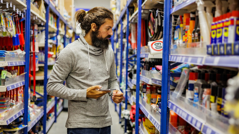 A man shopping for tools in a hardware store