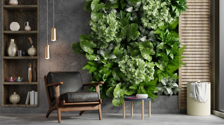 A modern living room features a feature wall covered with living plants.
