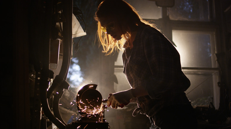 woman working tools in dark