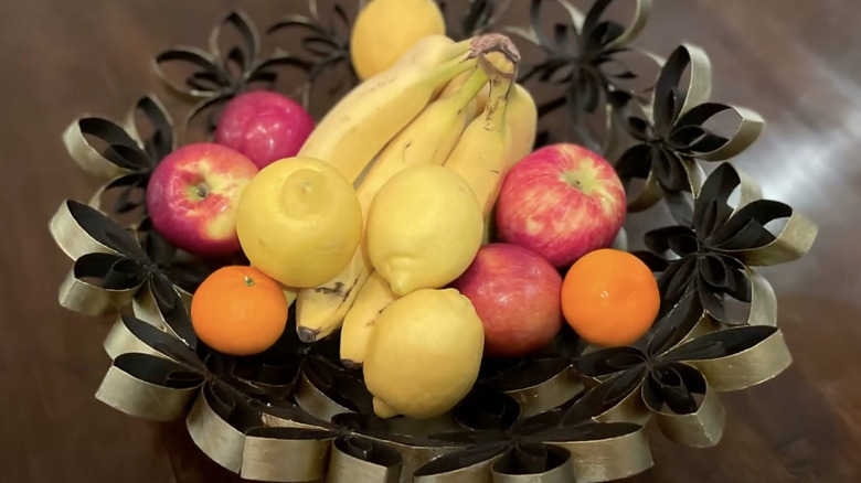 A fruit bowl made out of toilet paper rolls.