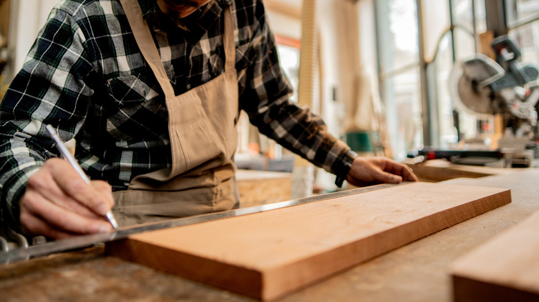 A man works on a woodworking project.