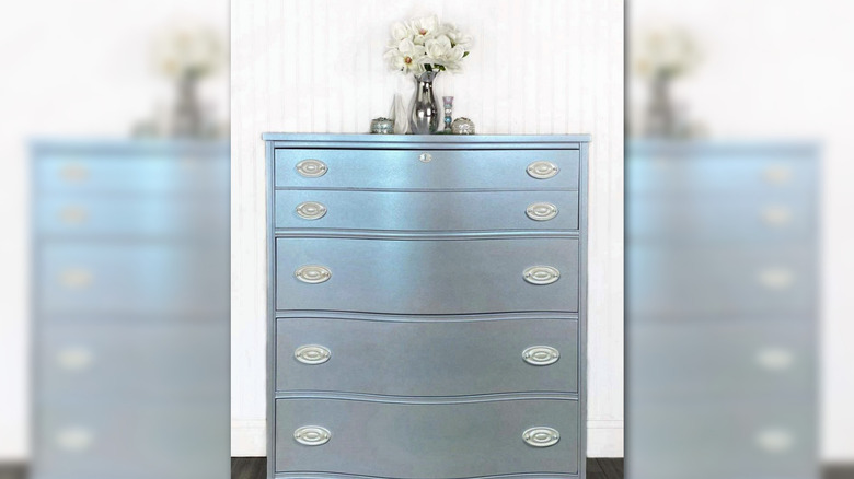 A shimmering chest of drawers painted with iridescent mica pigments.