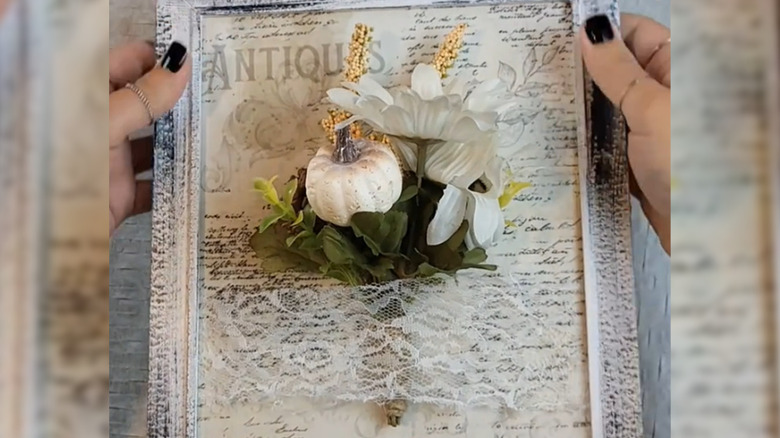 A framed piece of fall wall decor.