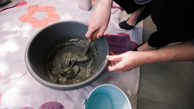 Someone mixing concrete for a craft