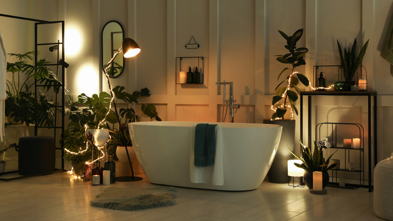 Dark, moody bathroom with plants