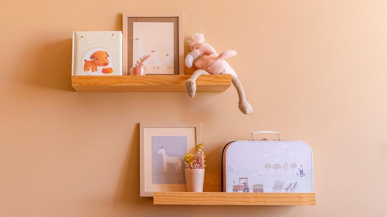 Child's items on floating shelves