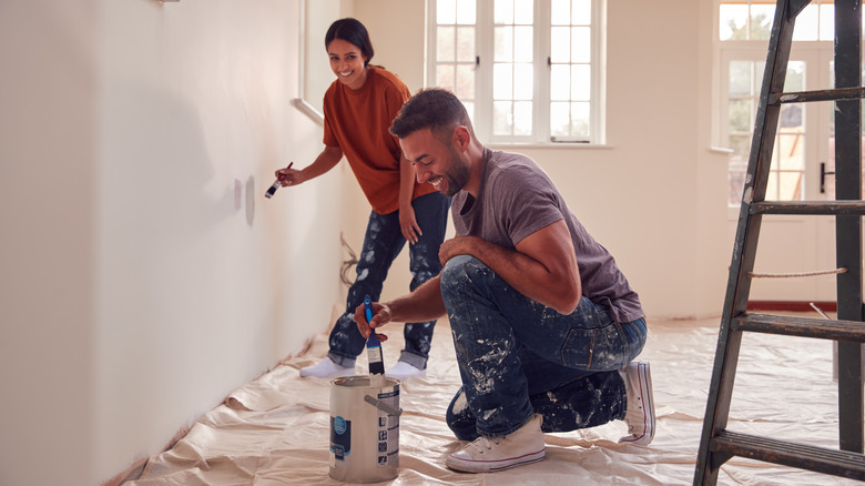 Couple painting a room