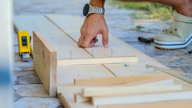Person building DIY wooden furniture
