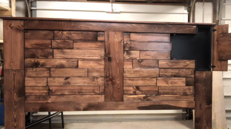 A wooden headboard with a hidden compartment.