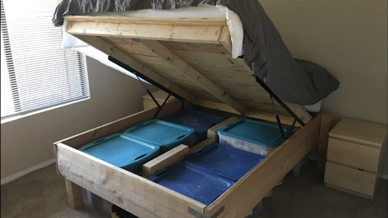 A bed with a pop-up gas spring storage.