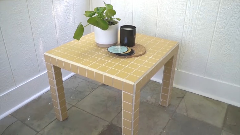yellow tiled table with plant