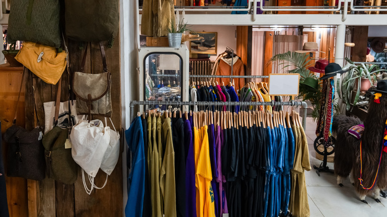 Secondhand clothing and accessories on store racks