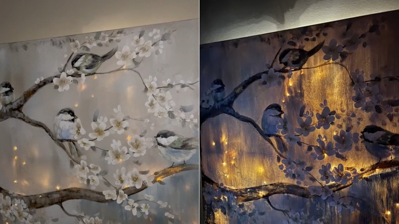 fairy lights behind a canvas print of birds in a dark room