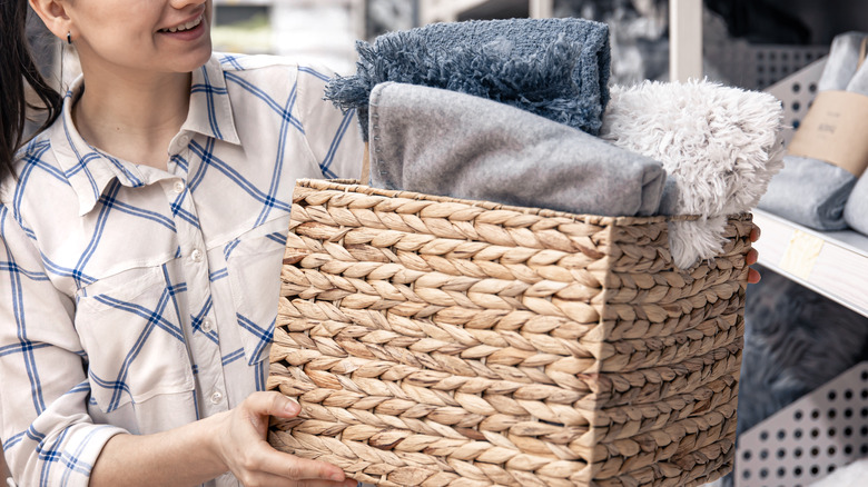 Person carrying woven basket