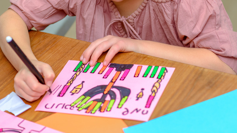A young girl creating original art for Hanukkah