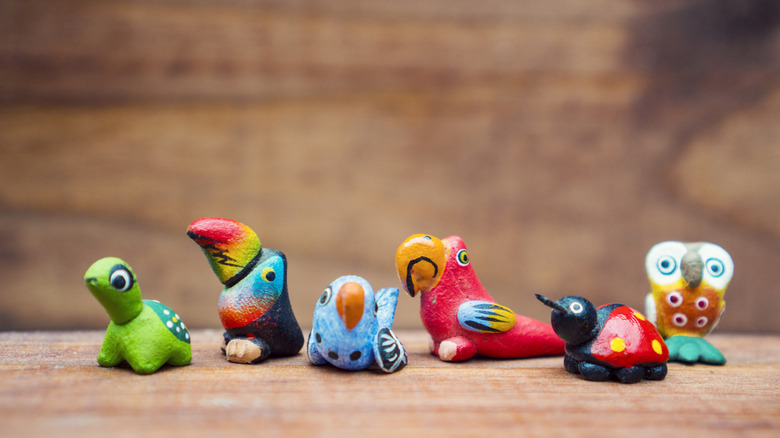 Collection of mini figurines on wood shelf