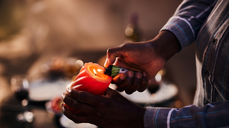 Person lighting a candle