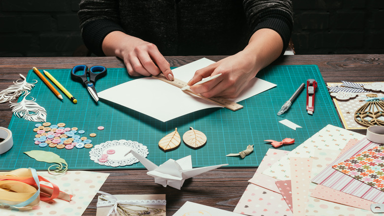 person measuring paper