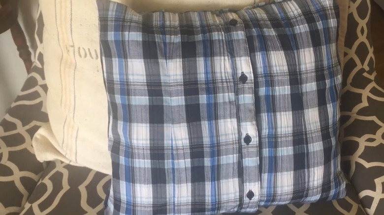 Pillow cover made out of an old blue, black, and white plaid button-up shirt