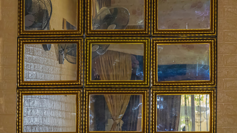 A large gridded mirror with gilt frames