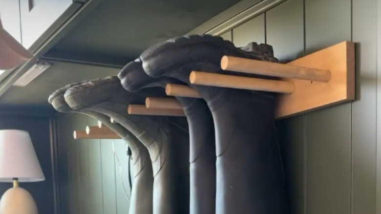 Boots hang on a DIY wall mounted shoe rack