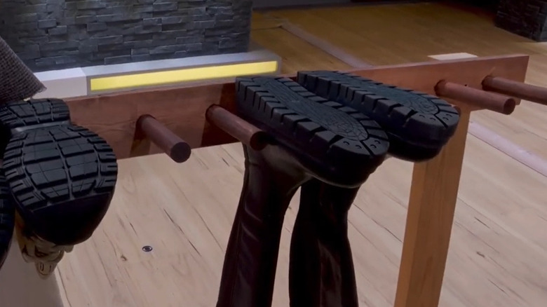 Boots hang on a freestanding storage rack