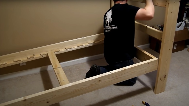 man assembling bunk beds