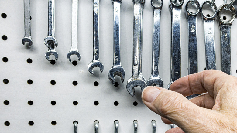 Small tools stored on a pegboard