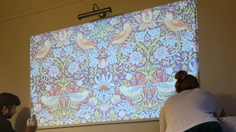 DIY wallpaper pattern projected for wall painting process