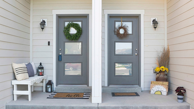 Two wood front doors with glass panels