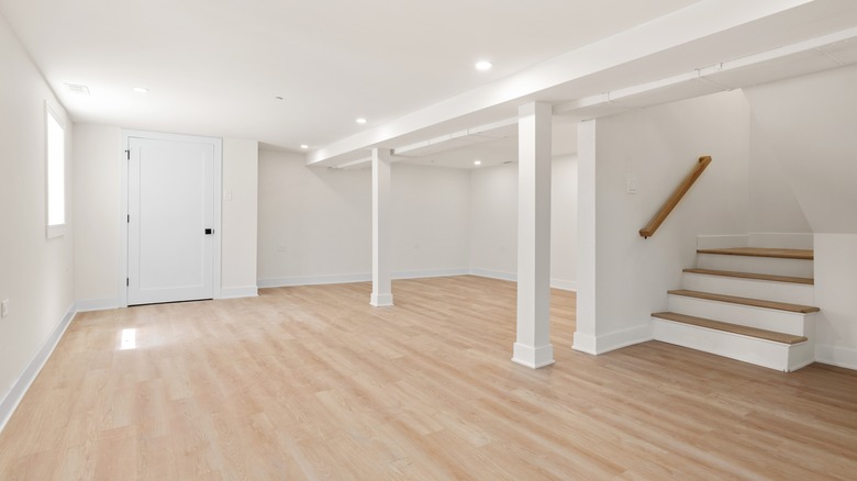 Clean, minimal basement with support beams