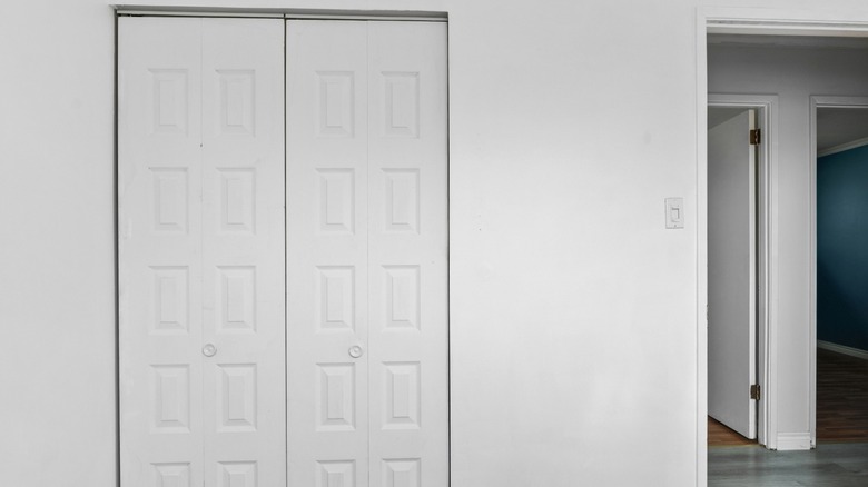 Turning basic white bifold closet doors into a chic sliding door is easy.