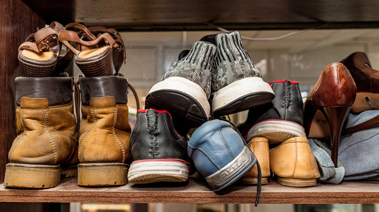 A messy pile of shoes on a shelf