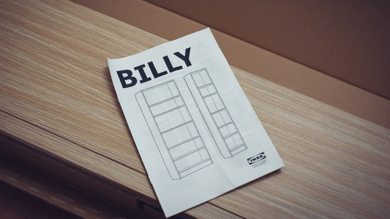 IKEA instruction manual for BILLY bookcase resting on wooden pieces