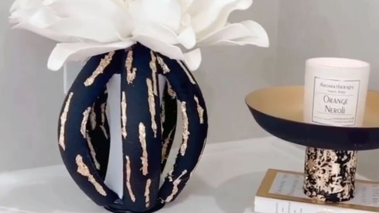 The pool noodle and vase combo set out next to other home decor pieces