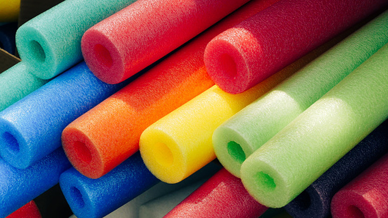 A bunch of colorful foam pool noodles