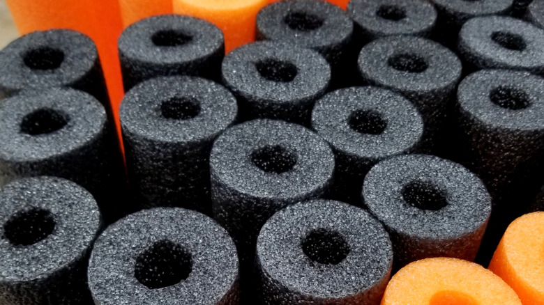 Top-down view of orange and black pool noodles