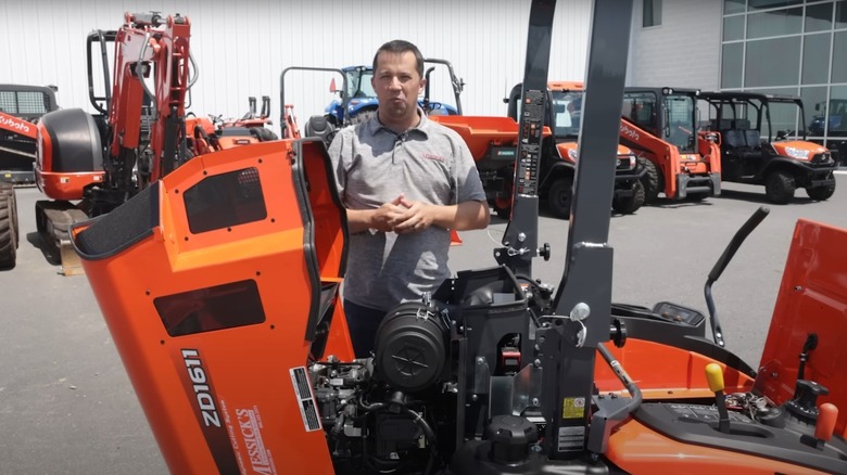 Man looking at the diesel engine of a Kubota zero-turn mower