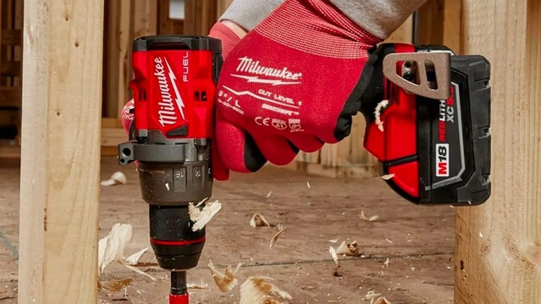 Person using a Milwaukee cordless drill