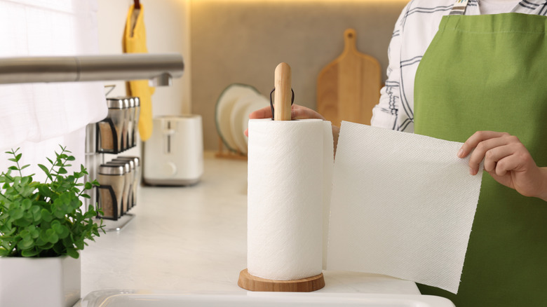 Person ripping off a sheet of paper towel