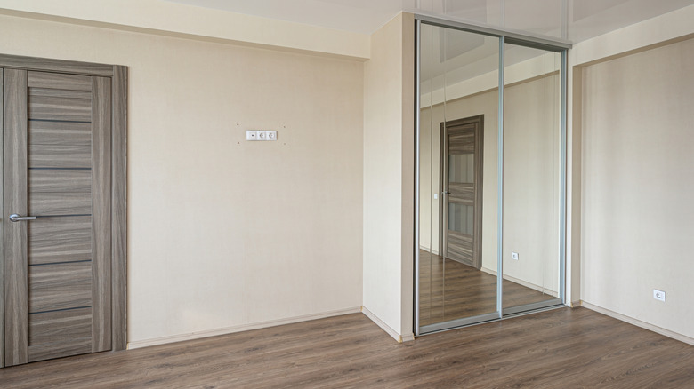 Empty bedroom with sliding closet doors