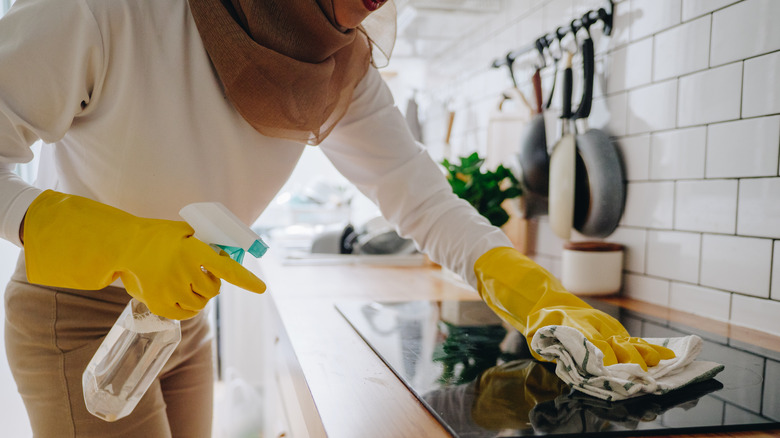 Hijabi woman cleaning kitchen 