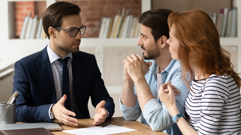 Couple talking to insurance broker