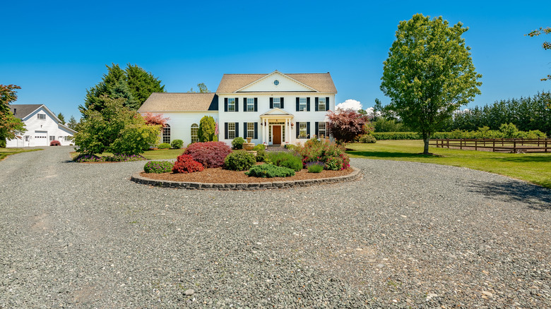 Colonial house with a circular gravel driveway