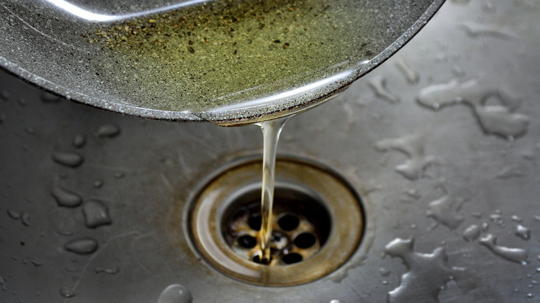 Cooking oil pouring into drain